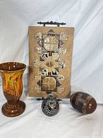 Photo showing all four items: ceramic vase, wooden tile wall plaque, small mosaic glass vase, decorative wooden egg.
