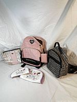 Full set of two backpacks and three cosmetic bags arranged together.