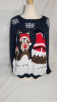 Front view of navy blue ugly Christmas sweater with reindeer and Santa stuck in chimney design on mannequin.