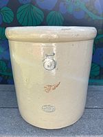 Front view of redwing crock showing blue '5' and pottery stamp with some marks and discoloration.