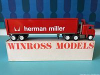 Photo of semi truck model with Herman Miller branding on trailer and Winross Models branded box underneath.