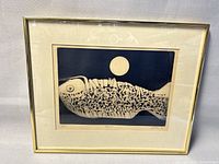 Full view of framed etching showing fish and moon design