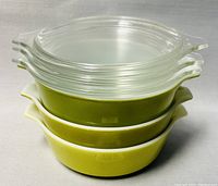 Stacked view of three Pyrex casserole dishes showing color and shape side handles