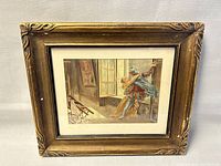 Photo of framed print with gold-toned ornate wooden frame and vintage scene inside