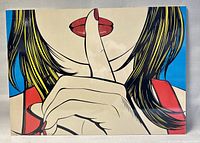 Full front view of pop art print showing a woman with finger to lips in shushing gesture.
