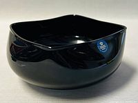 Photo showing the glossy black crystal bowl with a modern square shape and smooth finish.