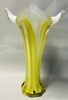 Side angle emphasizing the vertical color stripes and the blended yellow and white glass cased construction.
