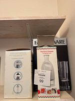 Photo showing the Euro Chopper box with its white plastic body and plunger top, alongside the Faber Ware blender box with a black base and clear pitcher.