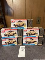 Four boxed, sealed 1/25 scale model kits of Ace Hardware 1929 Ford Model A Roadster assembled kit by ERTL Collectibles, stacked together.