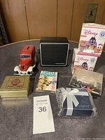Overall collection of items including model truck, mystery mini boxes, black speaker, collectible car, Turtle Power booklet, and decorative boxes.