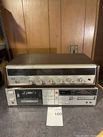 Emerson stereo FM-AM receiver with wood paneling and silver front control panel with dials and buttons.