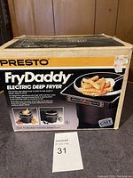 Photo of the front and top side of the Presto FryDaddy box showing branding and product information.