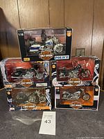 Overall view of five sealed Harley-Davidson 1:18 scale die-cast motorcycle models displayed stacked on a flat surface