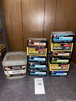 Overview of multiple boxes of exterior screws stacked, including a large container labeled Grip Rite High Performance Exterior Screws.