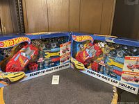 Two Hot Wheels Ready-to-Race Car Builder boxed sets side by side, showing front view with contents visible through packaging window.