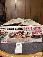 Box of Dayes Indoor Electric Bar-B-Q Grill with imagery showing grilled food.