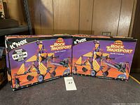 Two unopened K'Nex Lost Mines Rock Transport building sets in original boxes showing the assembled model on the front.