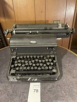 Front view of the vintage Royal typewriter showing keys and Royal brand badge with visible wear and heavy usage marks.