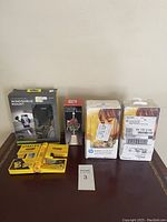 Photo showing full lot of items including windshield mount, dinner bell, Stanley tool kit, and HP photo paper cartridges.