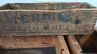 Close-up photo showing lettering on one wooden box labeled 'Terminal Cream Cheese'.