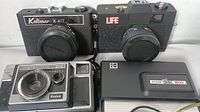 Front view of four cameras: Kalimar K-677, Life camera, Kodak Instamatic 315, Kodak Disc 4100.
