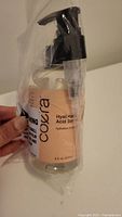 Photo of the front of Coera Hyaluronic Acid Serum, showing label and pump dispenser, bottle sealed in plastic wrap.