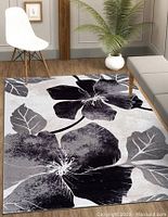 Full view of the area rug laid out in a room, displaying the floral design.