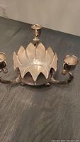 Close-up image of the silver plated lotus centerpiece with three candle cups showing the design and condition.