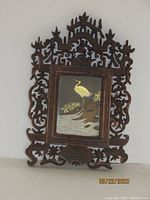 Front view of Chinese carved wooden frame with exotic bird and intricate openwork design, showing overall condition and size.