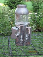 Front view of vintage metal and glass bus coin slot with lever handle