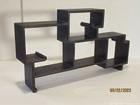 Photo of a vintage Chinese Ming style rosewood etagere with open rectangular and cubical compartments.