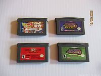 Four Game Boy Advance cartridges laid out showing their front labels for identification.