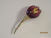 Front side image of purple iris flower brooch with gold-tone stem and rhinestone accents