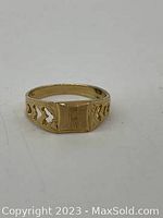 Front view of 14K gold ring with engraved letter 'R' and cut filigree heart shapes on sides.