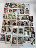 Front view showing arranged 40 assorted MLB baseball player trading cards in protective sleeves, featuring multiple players and card designs.