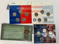 Full view of two carded Hallmark American Spirit Collection state quarter sets from 1999 and 2000 along with a Charles M. Schulz commemorative medal card.