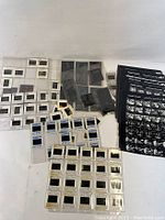 Various vintage photographic negatives and slides spread out on a surface