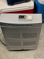Front view of silver Dayton air cleaner with remote on top