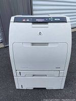 Front view of the HP Color LaserJet 3600n Q5987A color laser printer showing controls, logo, and paper trays.