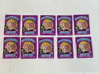 Ten unopened vintage Garbage Pail Kids sticker packs arranged in two rows of five on a white background.
