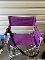 Front view of the purple sports chair showing the seat, backrest, and aluminum frame.