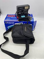 Polaroid 600 Business Edition 2 instant camera with original box and carrying case displayed together