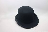 Full view of the black felt top hat showing rounded crown and curled brim