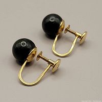 Two 14kt gold screw-back earrings with smooth polished dark green jade orbs, 8mm diameter, shown on plain background.
