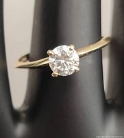 Front view of ring on display stand showing stone and band