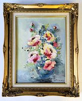 Full view of the floral oil painting housed in an ornate gold carved wood frame showing the entire artwork and frame.