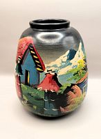 Front view of the hand painted vintage Peruvian ceramic pot showing colorful traditional countryside scene with figures and houses.
