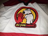 Close-up of embroidered Brian and fire hydrant logo with 'do you mind?' text