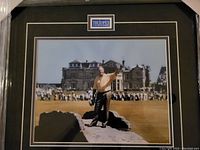 Full view of the framed color photo of Jack Nicklaus standing on Swilcan Bridge at St. Andrews during farewell round at The Open 2005, with crowd and old building in background.