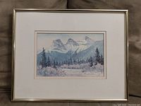 Full view of the framed watercolor print in a silver metal frame with white matted border, showing "The Three Sisters" mountain landscape.